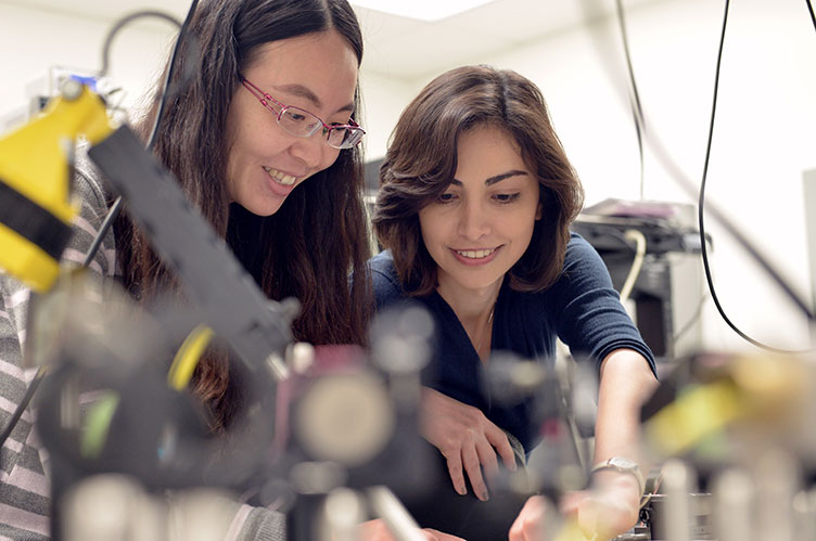 Female student and professor work together in a lab