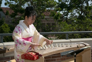 Woman in kimono plays traditional Japanese instrument