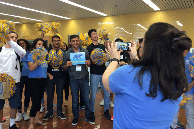 A future UCLA student garners cheers from fellow students at Bruin Bound event.