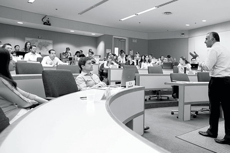 Students listen to a professor in a classroom.